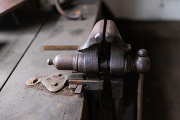 Vintage tools on a bench lit by a window, vice, gunsmith, gun, smith, blacksmith, classic, rusty, colonial era