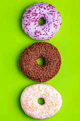 Three tastes of donuts: berry, chocolate and vanilla
