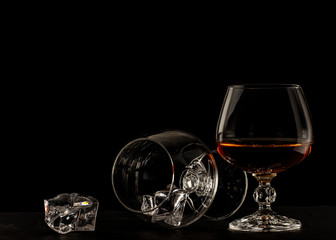 A glass of brandy on a black background