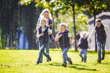 October 6, 2018 Ukraine. Kiev. theme family outdoor activities. big friendly Caucasian family six mom dad four children playing football, running ball on lawn, green grass lawn near house sunny day