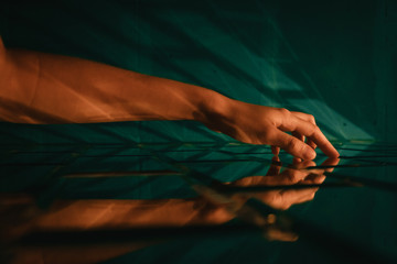 Female hand touching stylized designer brick glass wall
