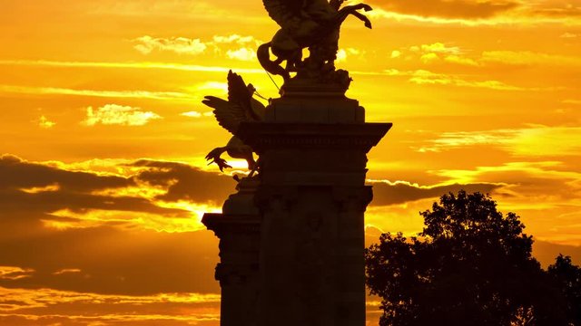 Time Lapse of a beautiful sunrise in Paris. The sun rises behind one of the many monuments in Paris.
