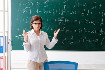 Female math teacher in front of the chalkboard 
