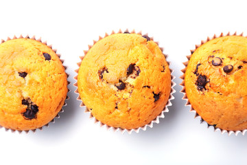 Assorted with Delicious homemade cupcakes with raisins and chocolate isolated on white background. Muffins. Top view. Copy space.