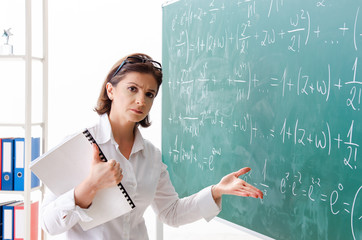 Female math teacher in front of the chalkboard 