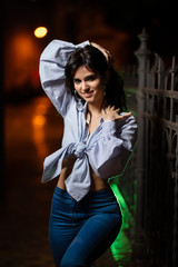 Attractive woman walks through the city at night