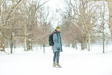 Young man with backpack on the snow.