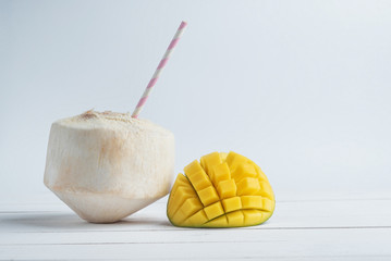 Naklejka na ściany i meble Half of mango and coconut mix isolated on white background.