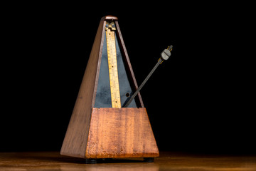Detail of an old mechanic musical metronome