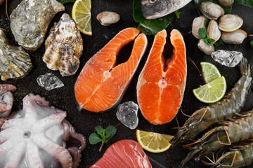 assorted fresh fish on black background