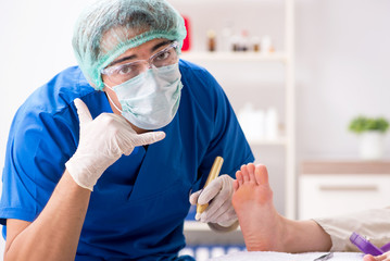 Podiatrist treating feet during procedure
