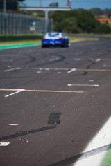 Speedy supercar on the road during the race created some drift on the asphalt