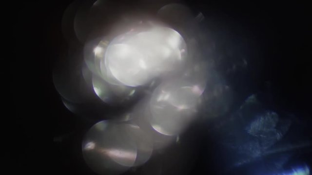Combination of defocused particles in warm and cold hue, randomly changing shape.