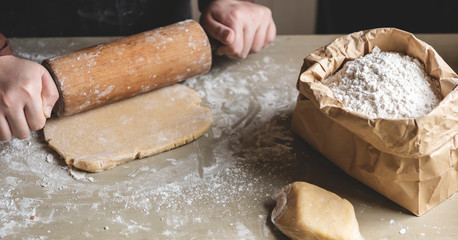 Baker preparing dough with a rolling pin