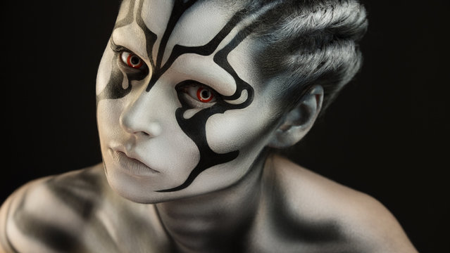 Creative fantastic appearance of alien creature in black and white colors is created through a make-up