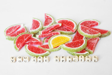 Psychological motivation of unusual, distinguished, outstanding people. The yellow slice of marmalade stands out among the many red ones