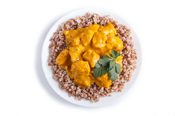 Buckwheat with chicken curry sauce isolated on white background.