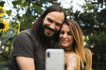 Couple taking a selfie with sunflowers