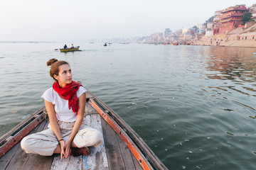 Fototapeta na wymiar Western woman on a boat exploring the River Ganges
