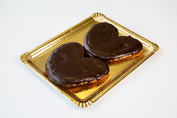 chocolate pastries in a gold tray on white background