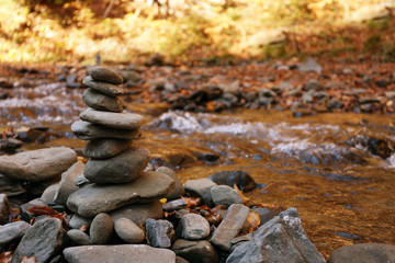 Fototapeta na wymiar Stack of stones near water. Space for text