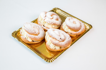 pastries in a gold tray on white background