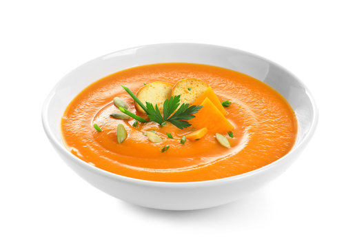 Dish with pumpkin cream soup on white background. Healthy food