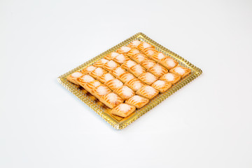 cookies on a gold tray with white background