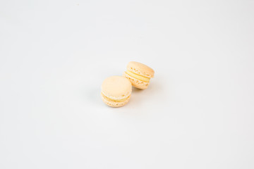 two white macaroons with white background