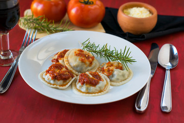 Making homemade pasta: Large round ravioli (Sorrentino) cooked, served on a dish, ready to eat