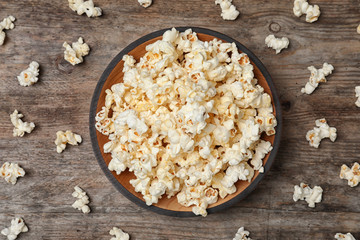Flat lay composition with popcorn on wooden background
