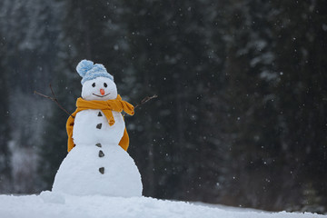 Fototapeta premium Adorable smiling snowman outdoors on winter day. Space for text