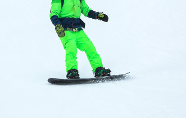 Fototapeta na wymiar Snowboarder on slope at resort, closeup. Winter vacation