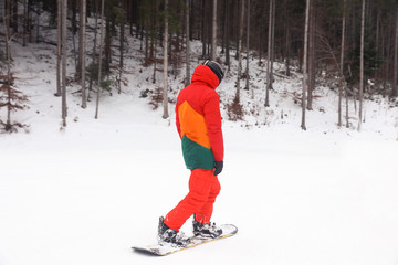 Fototapeta na wymiar Snowboarder on slope at resort. Winter vacation