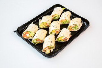burritos on a black tray with white background