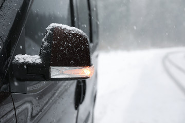 Naklejka na ściany i meble Car on snowy winter day, closeup view. Space for text