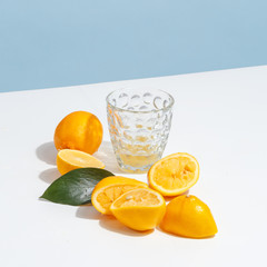 Glass on the table with squeezed lemons.
