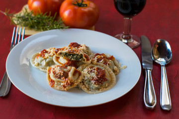 Making homemade pasta: Large round ravioli (Sorrentino) cooked, served on a dish, ready to eat