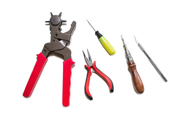 Puncher, awl, pliers, scalpel, notch isolated on white background. View from above