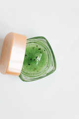 Kiwi jam in small jar on white background 