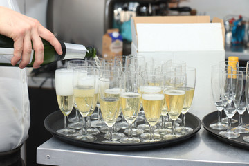 Pouring champagne in stylish glasses