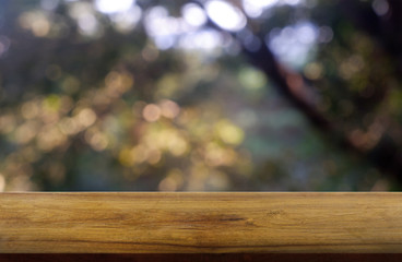 Empty wooden table in front of abstract blurred green of garden and trees .background. For montage product display or design key visual layout - Image.