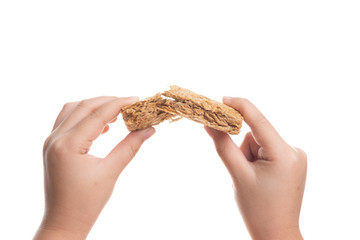 Broken Whole grain wheat biscuits breakfast cereal in hand