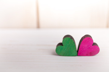 A colorful hearts on a wooden background