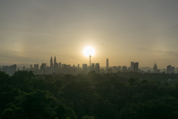 Fototapeta na wymiar Cloudy sunrise over silhouette of downtown Kuala Lumpur, Malaysia.