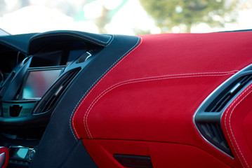 Car dashboard. Car interior details. Red and black alcantara with stitching