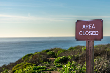  Area Closed sign, close up, ocean background