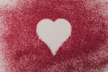 Symbol of heart between red grains