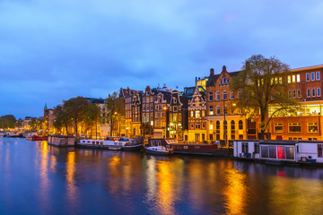 Fototapeta na wymiar Amsterdam Netherlands, night city skyline at canal waterfront