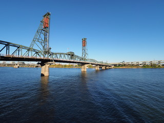 The Hawthorne Bridge over the Willamette River in Portland, Oregon, on a clear, cloudless autumn afternoon.